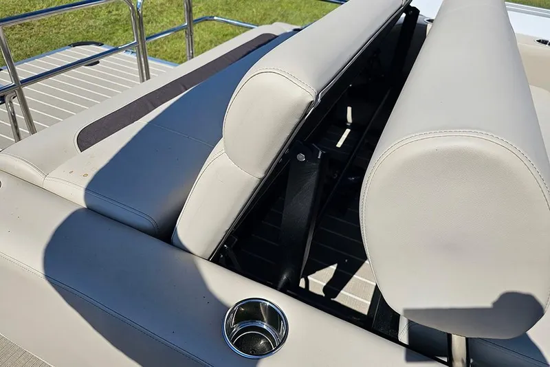 Slide: The Image of 2026 Bentley Pontoons 243 Legacy Swingback with open storage compartment and cup holders. - 16