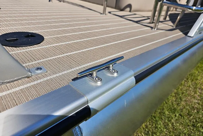 Slide: The Image of 2026 Bentley Pontoons 243 Legacy Swingback interior with open storage compartment and striped flooring. - 23