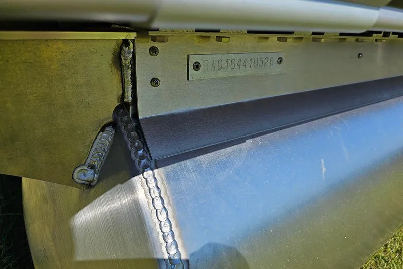 Slide: The Image of 2026 Bentley Pontoons 243 Legacy Swingback helm with luxurious captain's chair and sleek dashboard. - 24