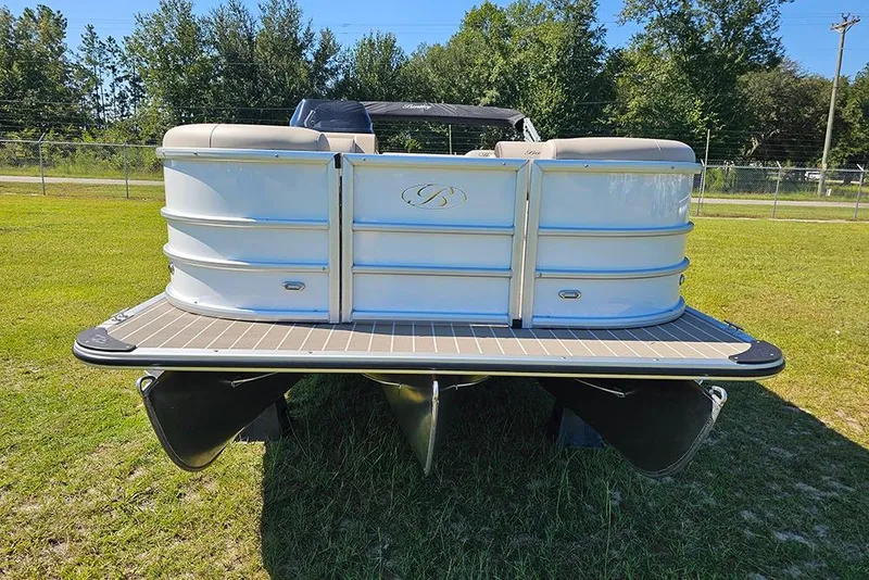 Slide: The Image of 2026 Bentley Pontoons 243 Legacy Swingback on grass, showcasing sleek design and modern features. - 4