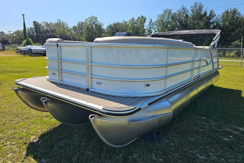 Slide: The Image of 2026 Bentley Pontoons 243 Legacy Swingback Sport3 on grass, showcasing sleek design and features. - 5