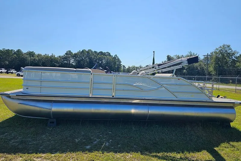 Slide: The Image of 2026 Bentley Pontoons 243 Legacy Swingback on grass, showcasing sleek design and modern features. - 6