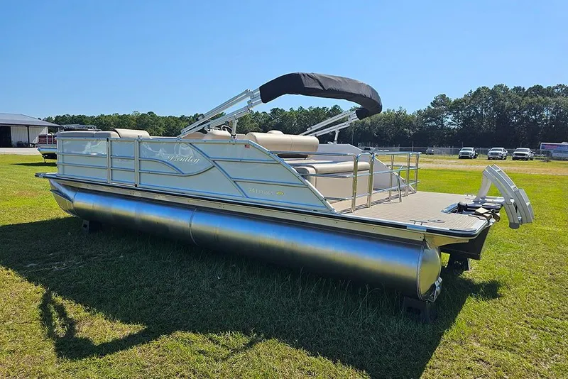 Slide: The Image of 2026 Bentley Pontoons 243 Legacy Swingback (Sport3) on grassy field, showcasing sleek design. - 7