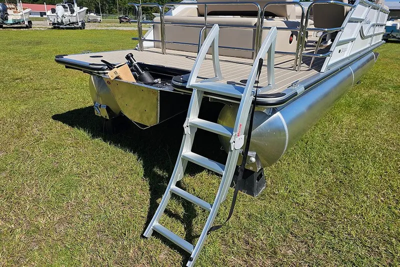 Slide: The Image of 2026 Bentley Pontoons 243 Legacy Swingback (Sport3) on grass, featuring sleek design and canopy. - 9