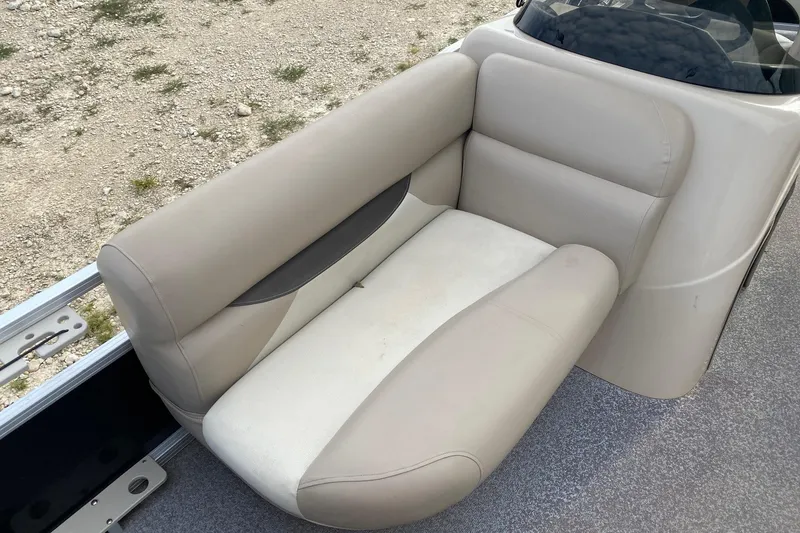 Slide: The Image of 2015 Sun Tracker Fishin' Barge 20 DLX boat seat, beige upholstery, outdoor setting. - 10