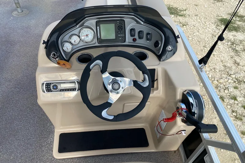Slide: The Image of Steering console of 2015 Sun Tracker Fishin' Barge 20 DLX with gauges and controls. - 5