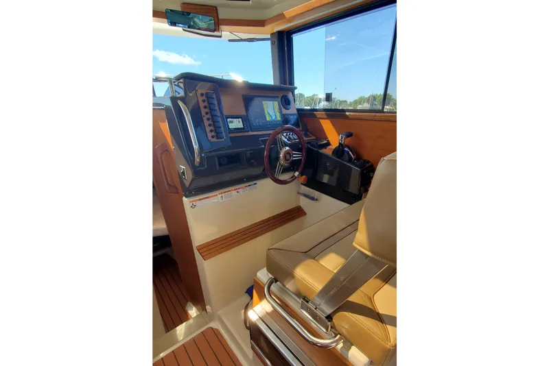 Slide: The Image of 2024 Ranger Tugs R-27 helm with modern controls and navigation system. - 17