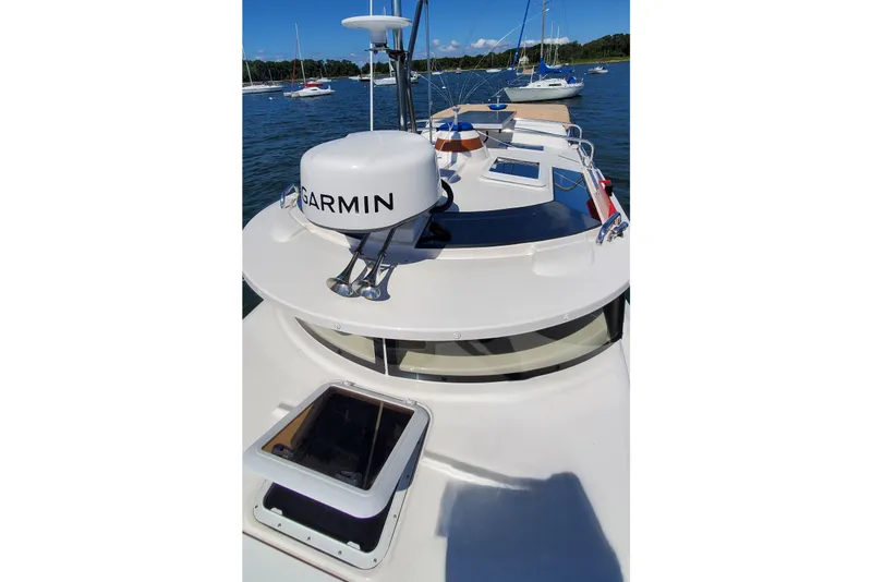 Slide: The Image of 2024 Ranger Tugs R-27 boat with Garmin radar, docked in a scenic marina. - 26