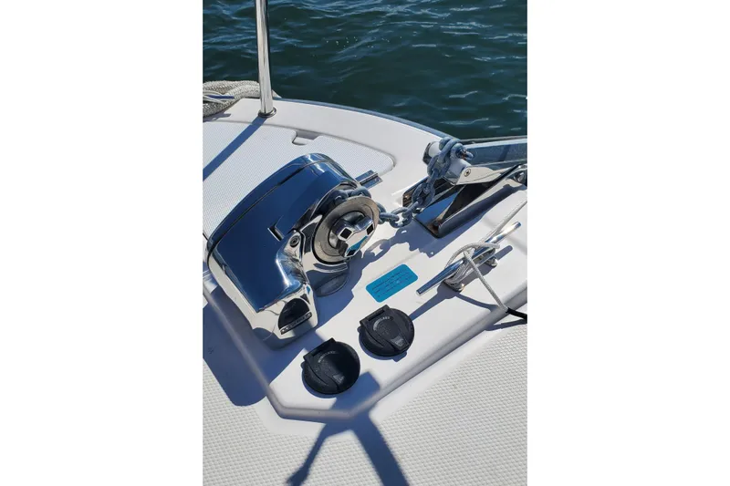 Slide: The Image of 2024 Ranger Tugs R-27 boat deck with anchor winch and rope cleat. - 27