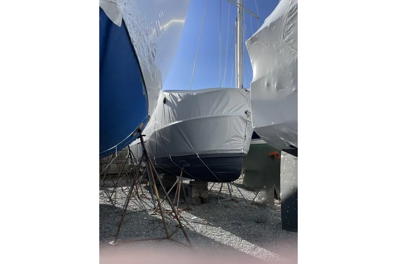 Slide: The Image of 2024 Ranger Tugs R-27 boat covered and stored on land. - 28