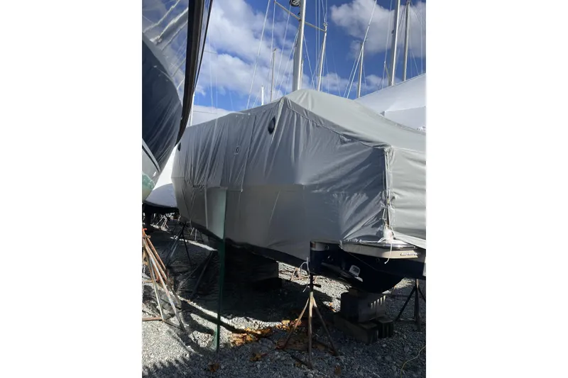 Slide: The Image of 2024 Ranger Tugs R-27 boat covered in protective tarp, stored outdoors. - 30
