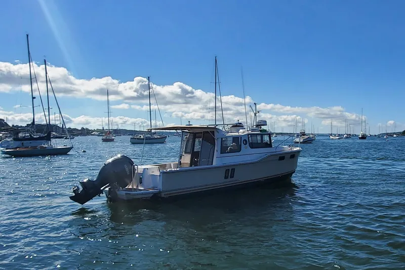 Slide: The Image of 2024 Ranger Tugs R-27 boat on a sunny day in a marina. - 6