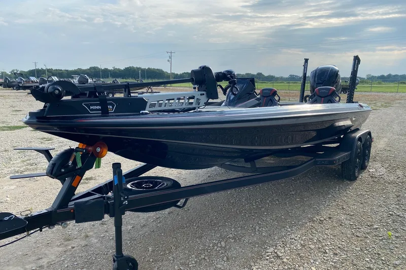 Slide: The Image of 2026 Skeeter ZXE21 fishing boat on trailer, featuring dual motors and sleek design. - 2