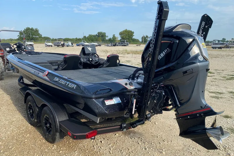 Slide: The Image of 2026 Skeeter ZXE21 boat with Yamaha engine on a trailer in a parking area. - 3