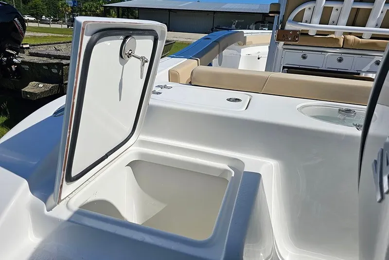 Slide: The Image of 2025 Sea Pro 242 Center Console boat interior with open storage compartment. - 10
