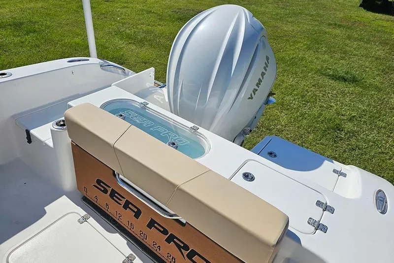 Slide: The Image of 2025 Sea Pro 242 Center Console boat with Yamaha engine on grassy background. - 11