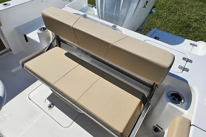 Slide: The Image of 2025 Sea Pro 242 Center Console boat with beige cushioned seating and stainless steel fixtures. - 12