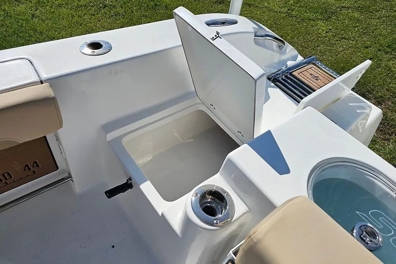 Slide: The Image of 2025 Sea Pro 242 Center Console boat interior with open storage compartment and seating. - 14