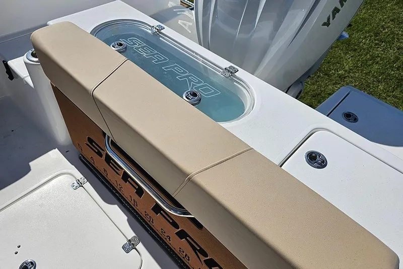 Slide: The Image of 2025 Sea Pro 242 Center Console boat with cushioned seating and storage compartments. - 15