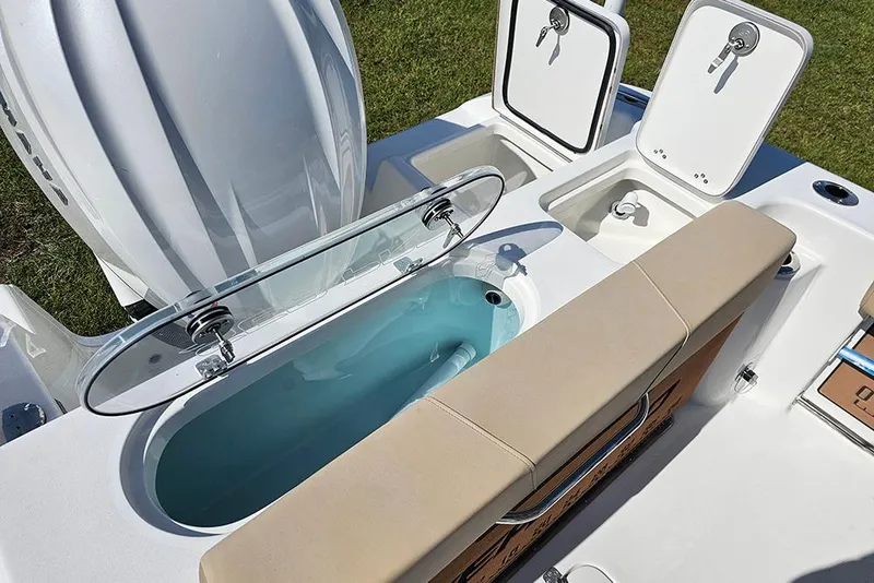 Slide: The Image of 2025 Sea Pro 242 Center Console boat with open storage compartments and seating. - 16