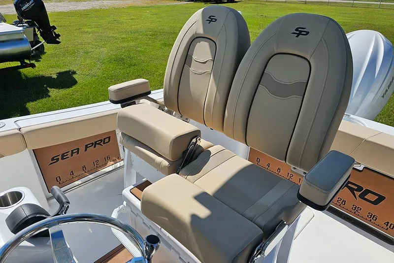 Slide: The Image of 2025 Sea Pro 242 Center Console boat seats with armrests and branded upholstery. - 18