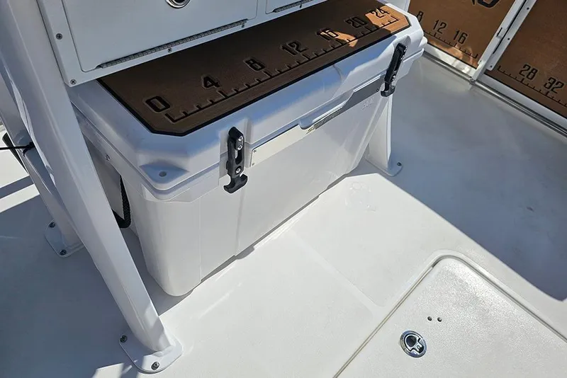 Slide: The Image of 2025 Sea Pro 242 Center Console boat interior with storage compartment and measuring board. - 19