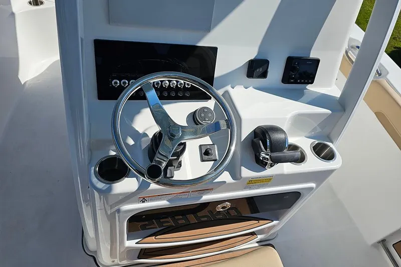 Slide: The Image of 2025 Sea Pro 242 Center Console boat helm with steering wheel and controls. - 20