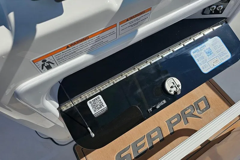 Slide: The Image of 2025 Sea Pro 242 Center Console boat dashboard with warning labels and QR code. - 21