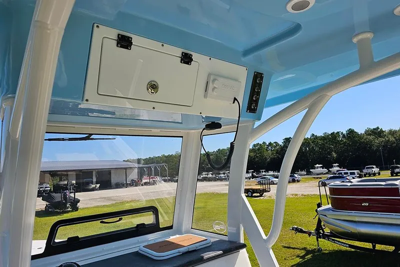Slide: The Image of 2025 Sea Pro 242 Center Console boat interior with storage and control panel. - 23