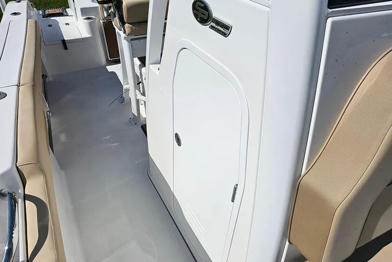 Slide: The Image of 2025 Sea Pro 242 Center Console interior with beige seating and white console. - 25