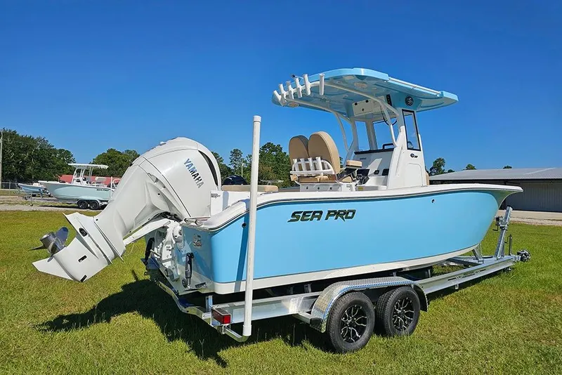 Slide: The Image of 2025 Sea Pro 242 Center Console boat with Yamaha engine on trailer, parked on grass. - 3