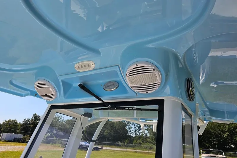 Slide: The Image of 2025 Sea Pro 242 Center Console boat with blue interior and mounted speakers. - 33