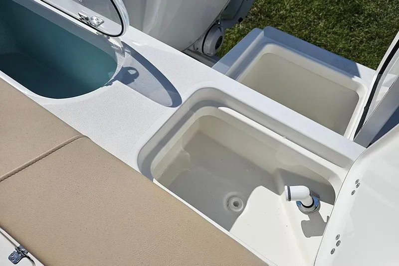 Slide: The Image of 2025 Sea Pro 242 Center Console boat with open storage compartments and seating. - 36