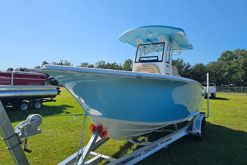 Slide: The Image of 2025 Sea Pro 242 Center Console boat on trailer, displayed outdoors under clear blue sky. - 5