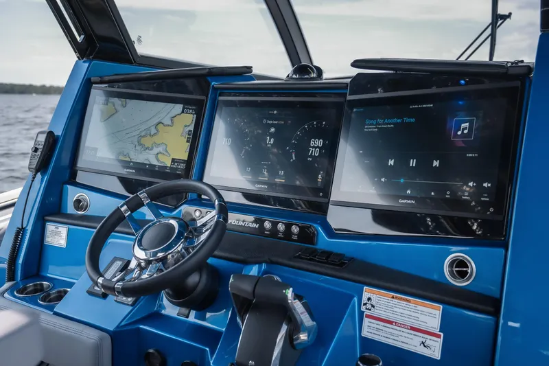 Slide: The Image of Dashboard of 2026 Fountain 43 SCX boat with navigation and entertainment screens. - 13