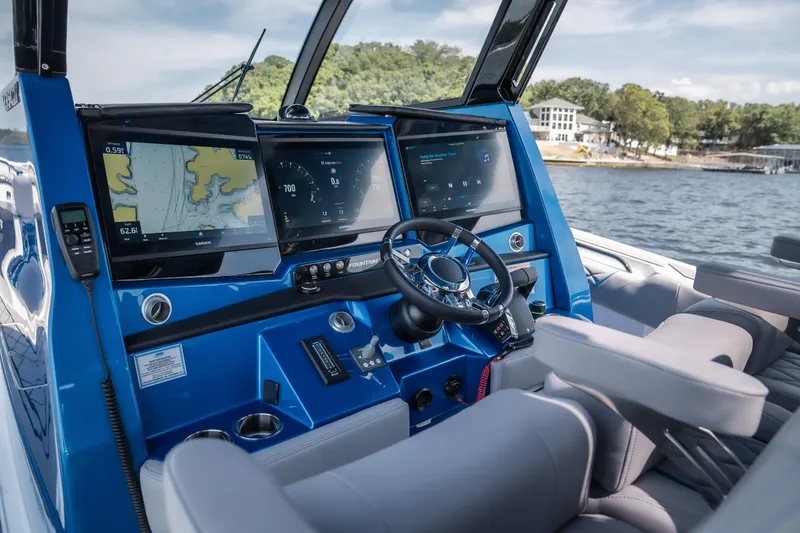 Slide: The Image of 2026 Fountain 43 SCX boat cockpit with advanced navigation displays and steering wheel. - 15