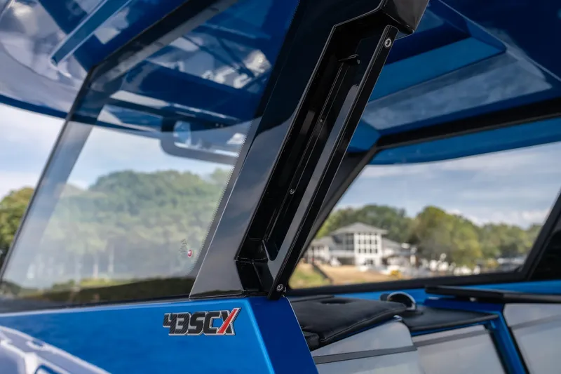 Slide: The Image of 2026 Fountain 43 SCX boat windshield detail with scenic background. - 17