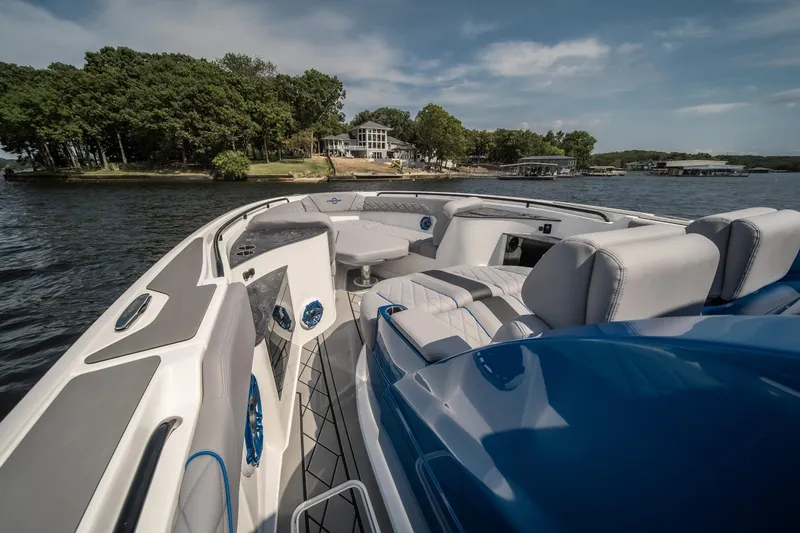 Slide: The Image of 2026 Fountain 43 SCX boat interior with luxurious seating on a scenic lake. - 20