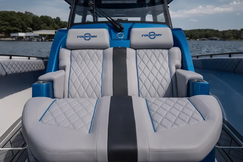Slide: The Image of Luxury seating on 2026 Fountain 43 SCX boat, featuring quilted upholstery and cup holders. - 30