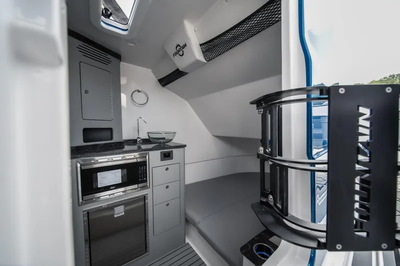 Slide: The Image of Interior of 2026 Fountain 43 SCX boat with modern kitchenette and seating area. - 35