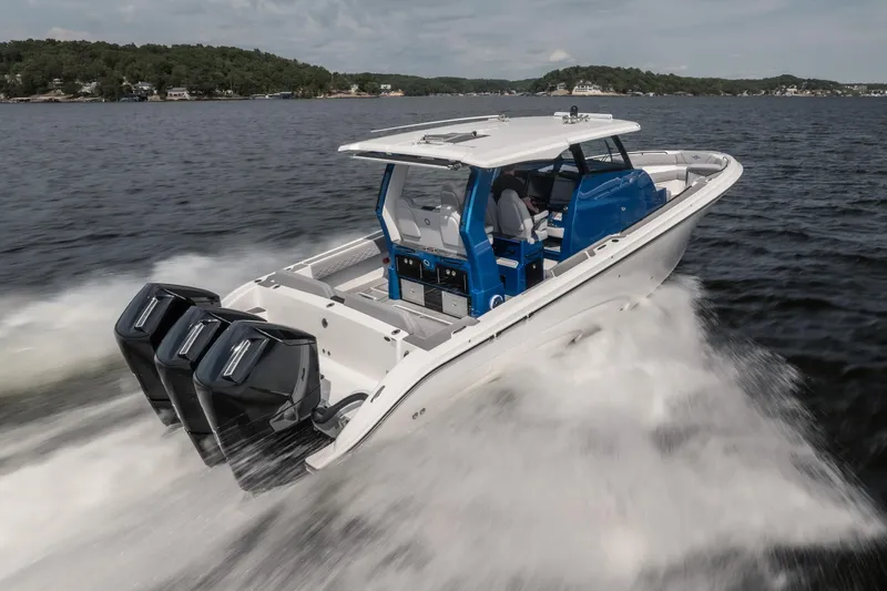 Slide: The Image of 2026 Fountain 43 SCX boat speeding on water with triple outboard engines. - 5