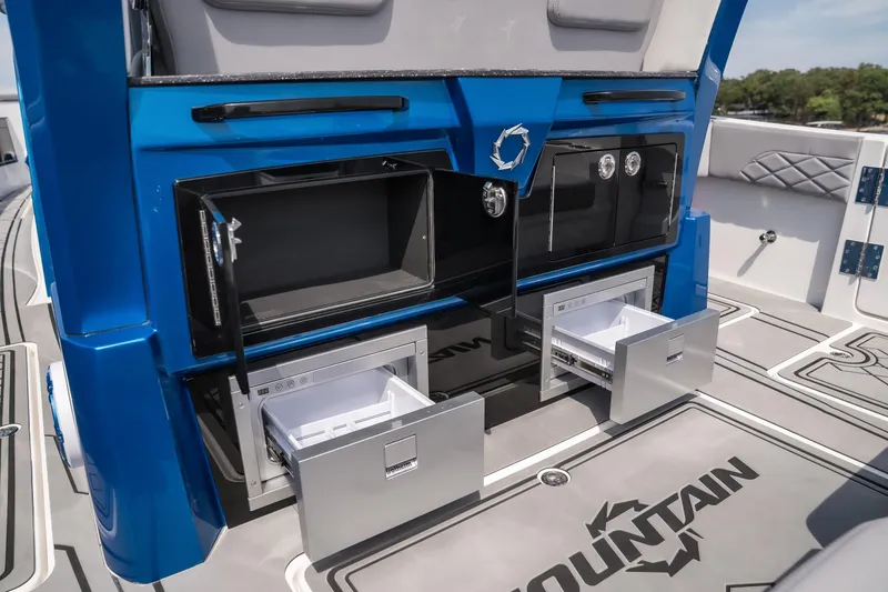 Slide: The Image of 2026 Fountain 43 SCX boat interior with open storage compartments and sleek design. - 9