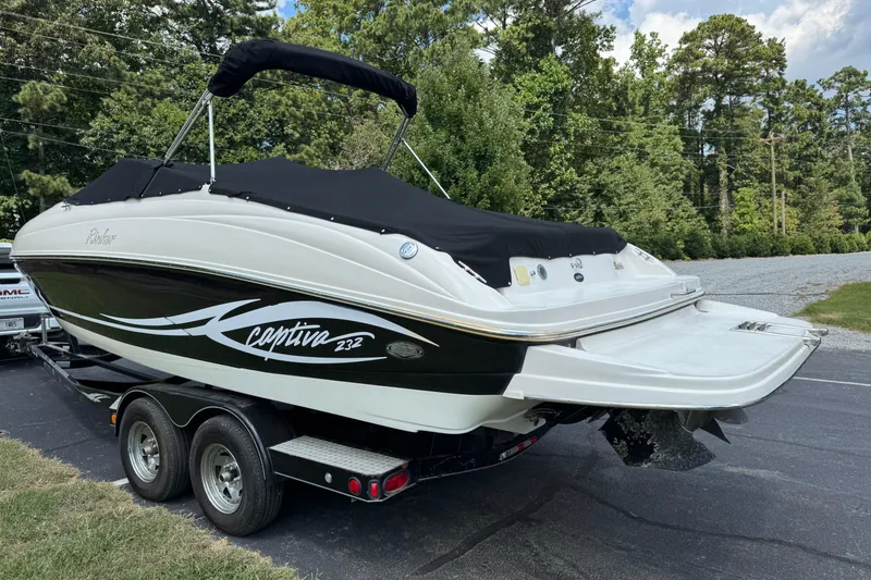 Slide: The Image of 2005 Rinker 232 Captiva Bowrider on trailer, covered, parked outdoors. - 28