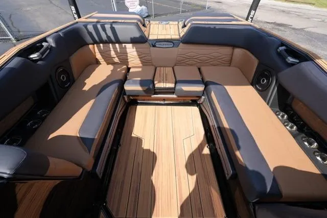 Slide: The Image of Luxurious 2026 Supra SL boat interior with tan and black seating, wood flooring. - 10