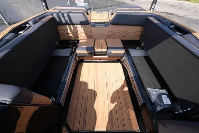 Slide: The Image of 2026 Supra SL boat interior with luxurious seating and wood finish. - 11