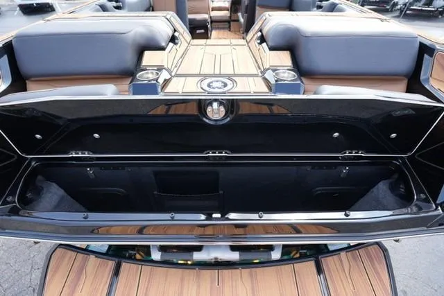 Slide: The Image of 2026 Supra SL boat interior with open storage compartment, featuring sleek design and luxurious seating. - 12