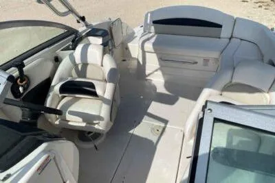 Slide: The Image of 2008 Chaparral Sunesta 224 boat interior with white seating and steering console. - 11