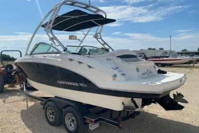 Slide: The Image of 2008 Chaparral Sunesta 224 boat on trailer, parked outdoors under a clear sky. - 3