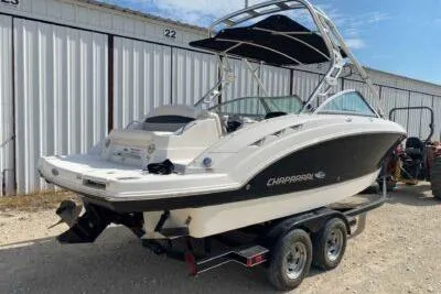 Slide: The Image of 2008 Chaparral Sunesta 224 boat on trailer, parked outdoors near storage units. - 5