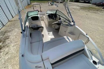 Slide: The Image of 2008 Chaparral Sunesta 224 boat interior with white seating and steering console. - 6